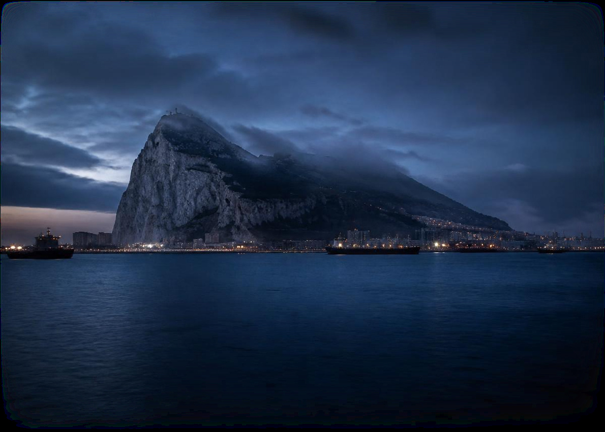 The Rock of Gibraltar at blue hour above the harbour